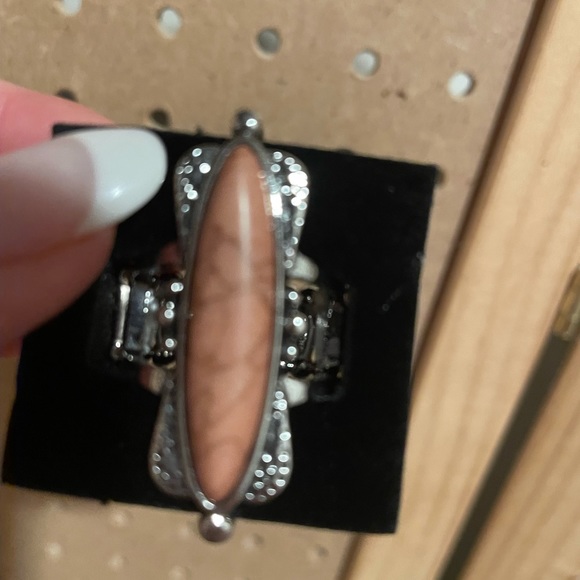 Large silver stretchy ring with slim oblong tan crackle stone.